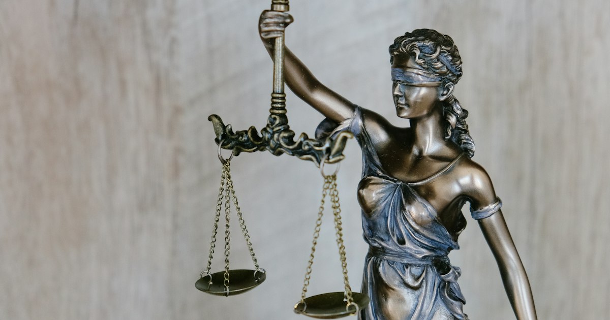 Balanza de la justicia sobre el escritorio de una oficina jurídica en Lima